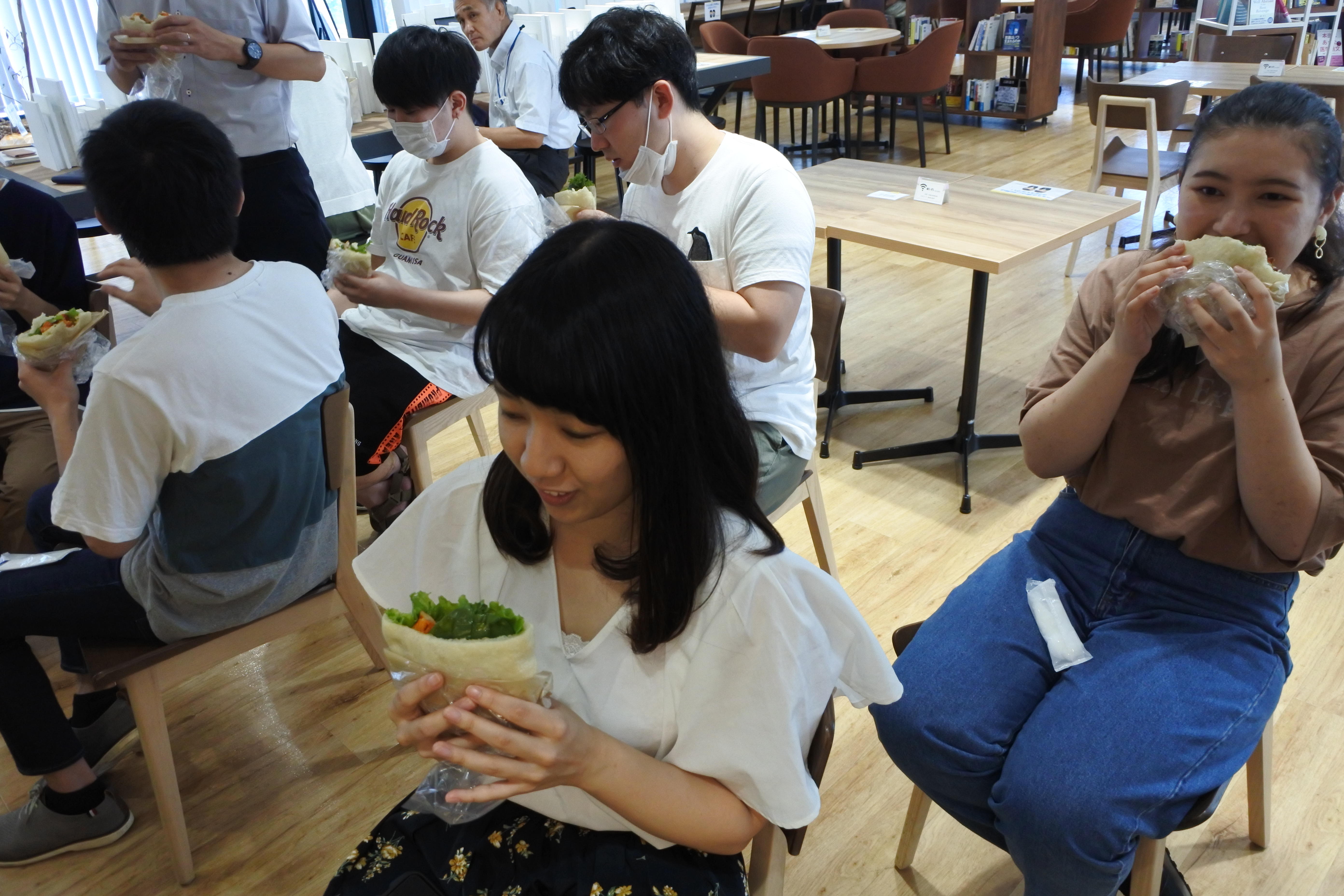 ピタパンサンド「エスニックサボーレ」を試食する学生たち