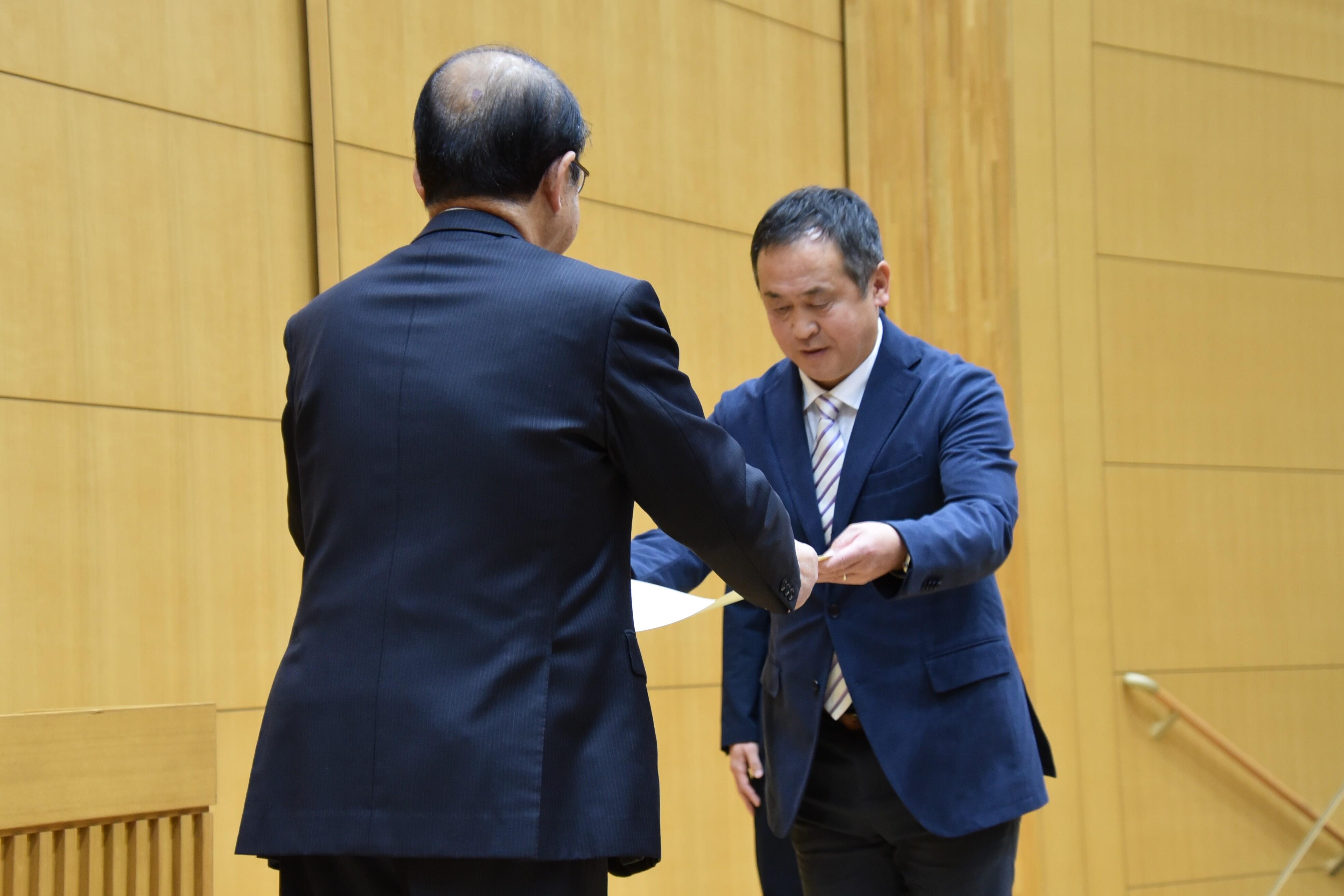 表彰状を受け取る米田監督